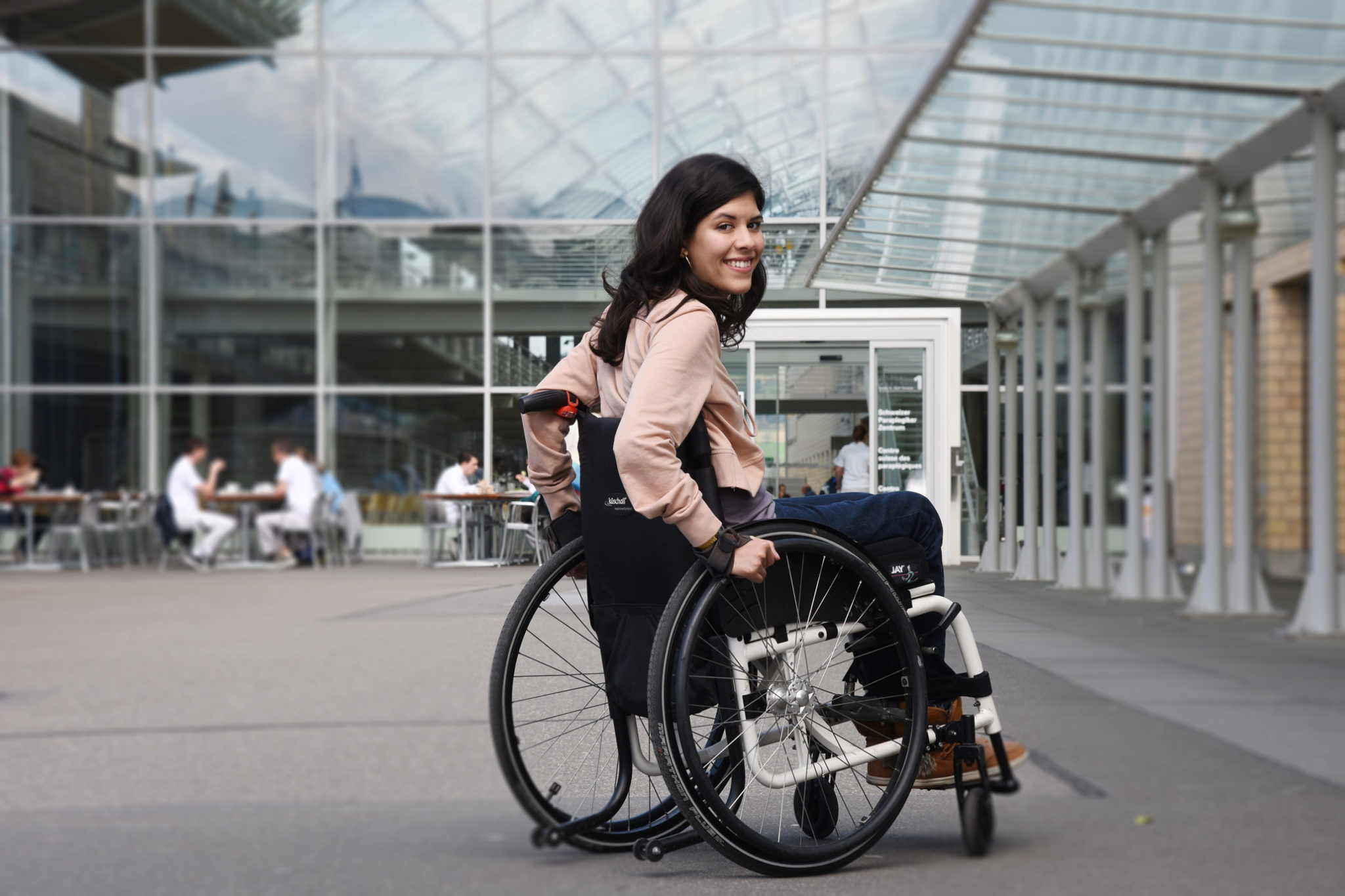 Woman in wheelchair in front of the Paraplegic Centre in Nottwil